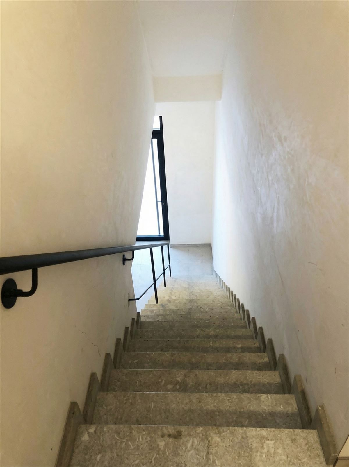 narrow-staircase-with-handrail