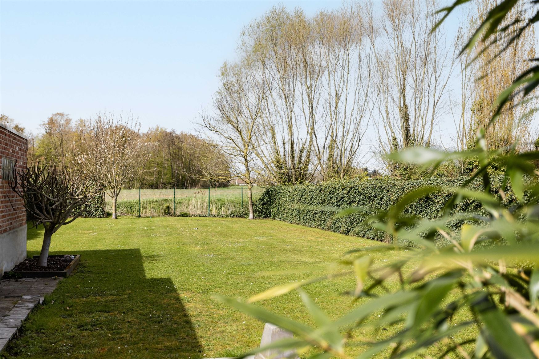 Wonen tussen water en open ruimte. Deze halfopen woning in de Koning Leopoldstraat 71 in Lovendegem kijkt vooraan uit op het Schipdonkkanaal en achter...