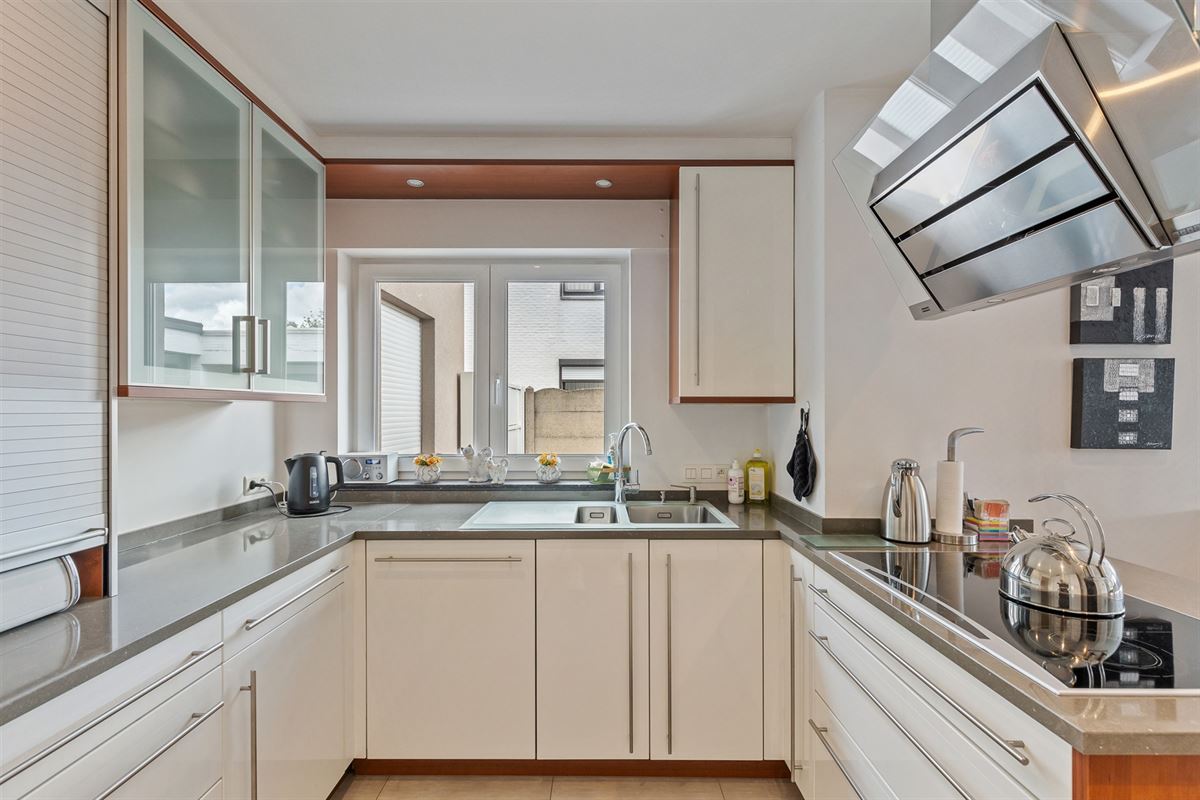 PERFECT ONDERHOUDEN GELIJKVLOERS APPARTEMENT MET 2 SLAAPKAMERS EN RUIME TUIN MET CARPORT EN BERGING TE HEUSDEN