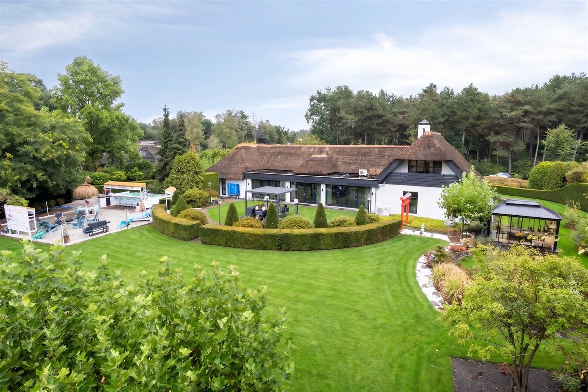 Knappe duo-villa op 8.843 m² in villawijk aan NL-grens.