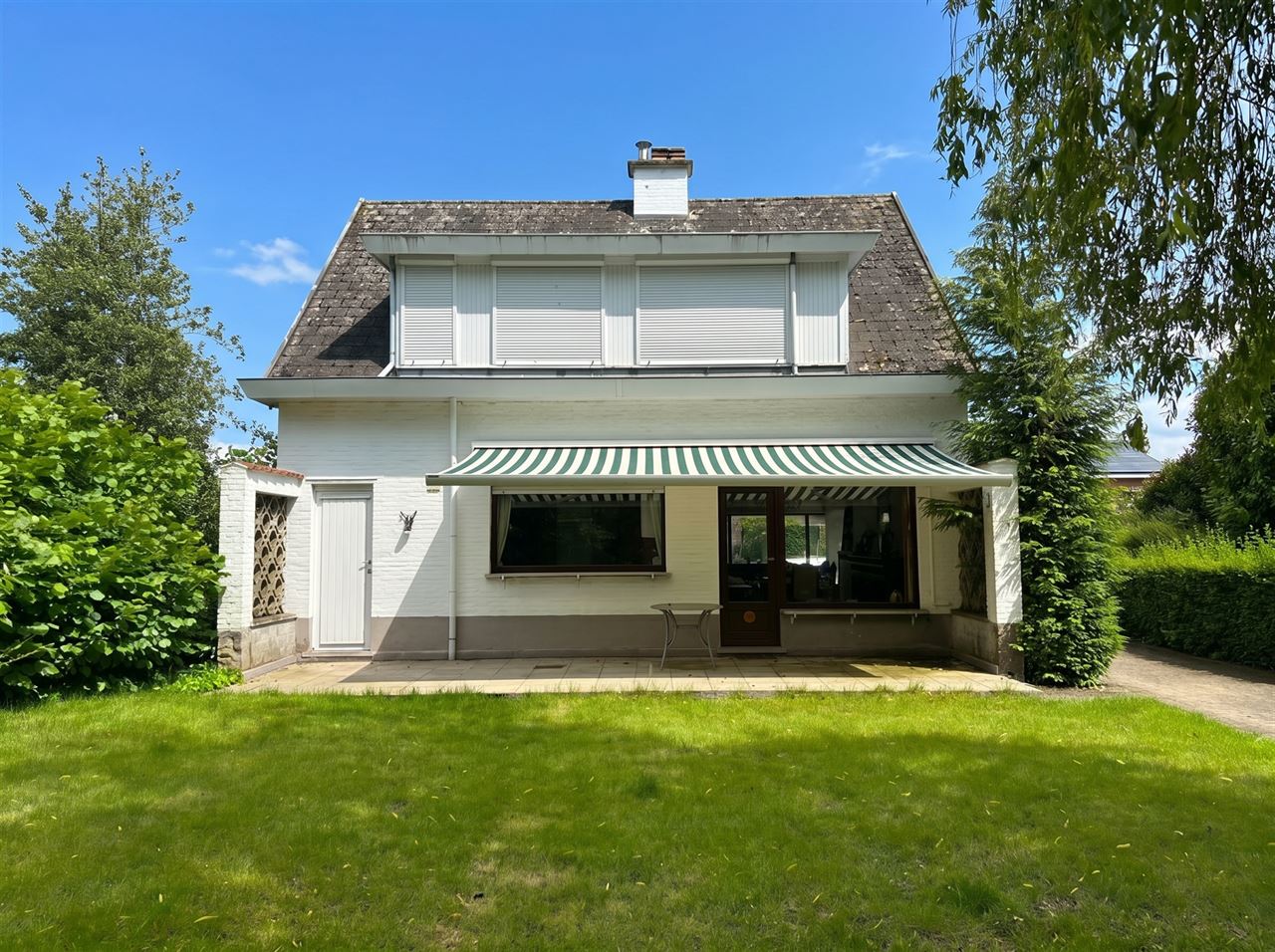 Te renoveren woning met 4 slaapkamers, 2 garages en tuin.