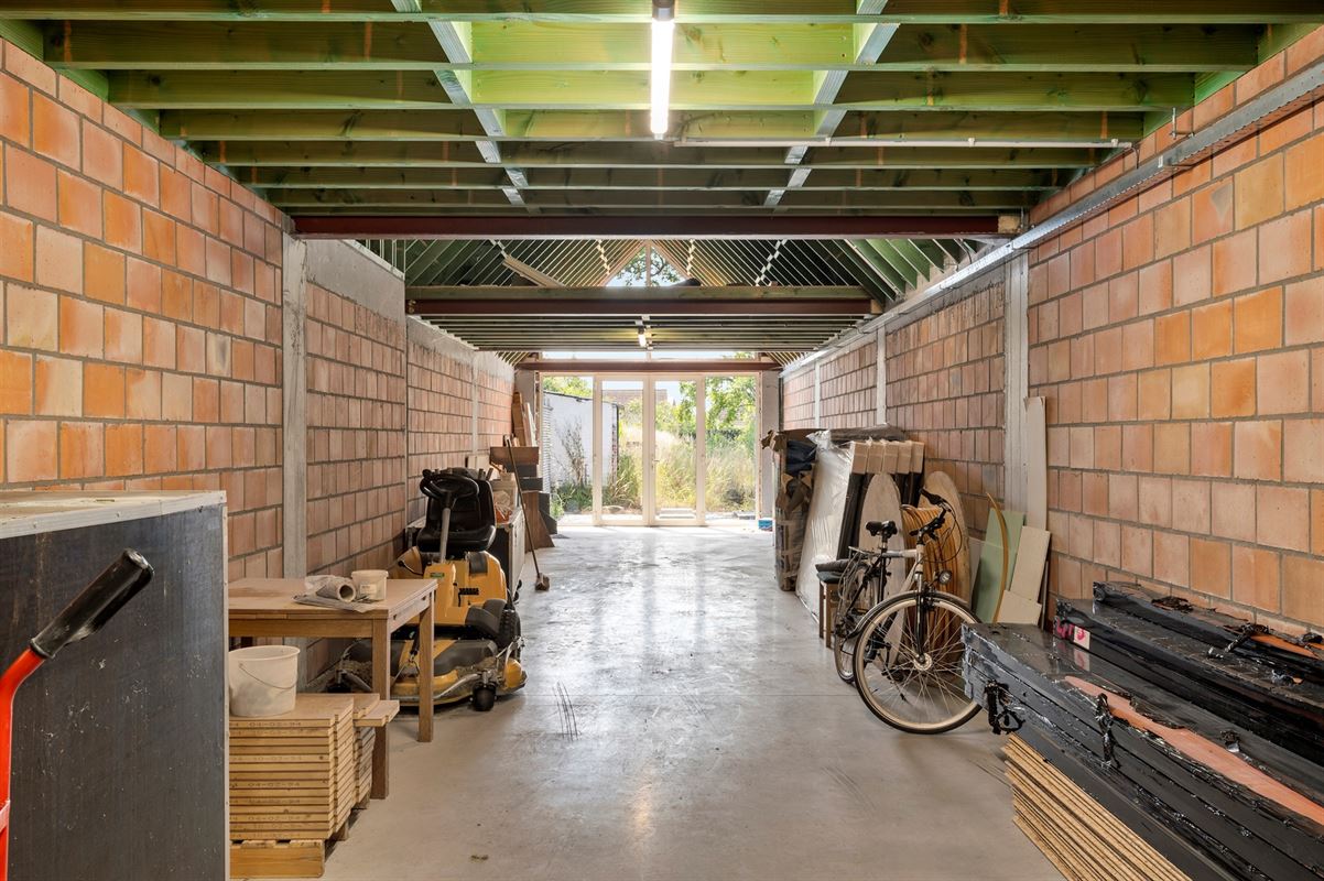 Rijwoning met grote garage/opslag en tuin